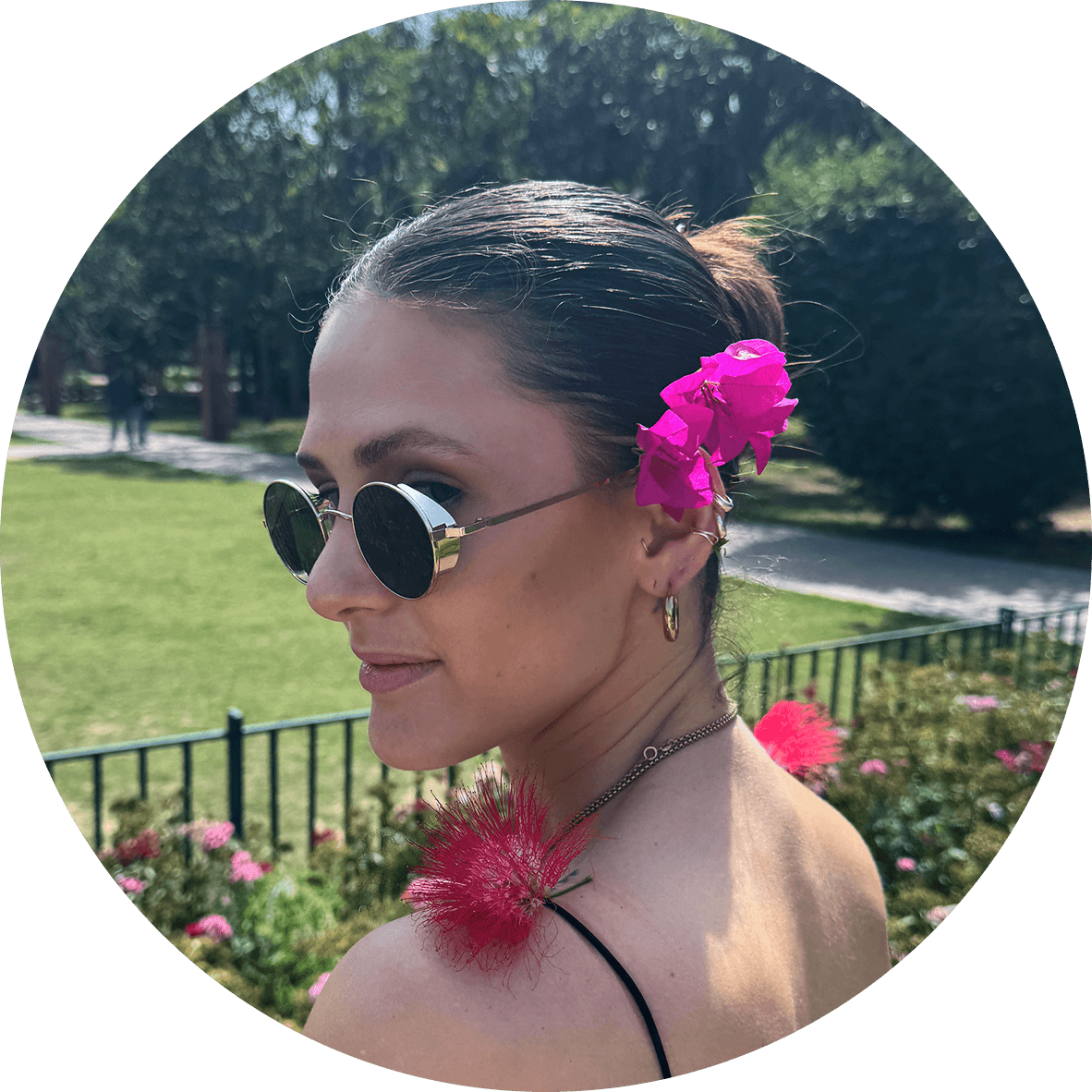 Caroline Jaworsky, profile portrait with a pink bougainvillea tucked behind her ear